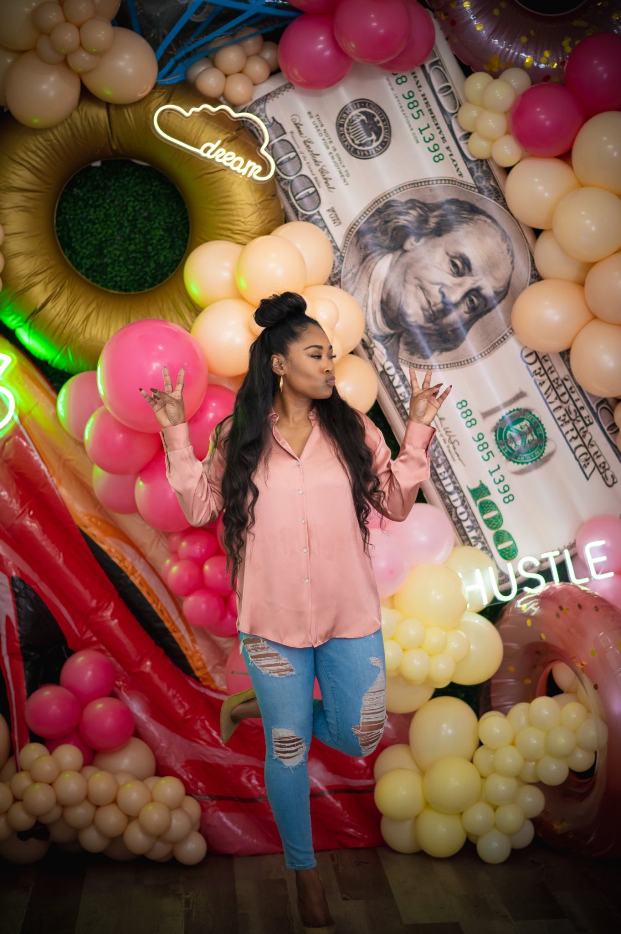 CeCe with a balloon installation backdrop